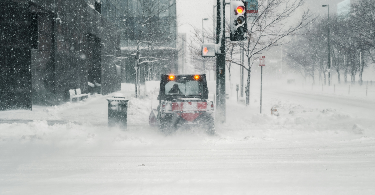 black car on snow covered road during daytime