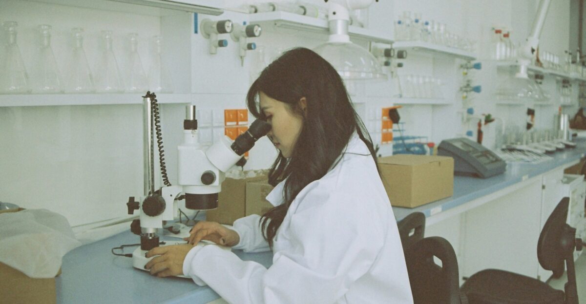 woman in white long sleeve shirt using white and black sewing machine