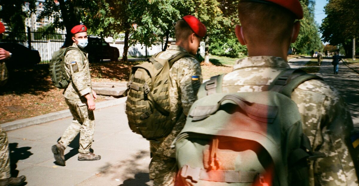 men in camouflage uniform standing on ground during daytime