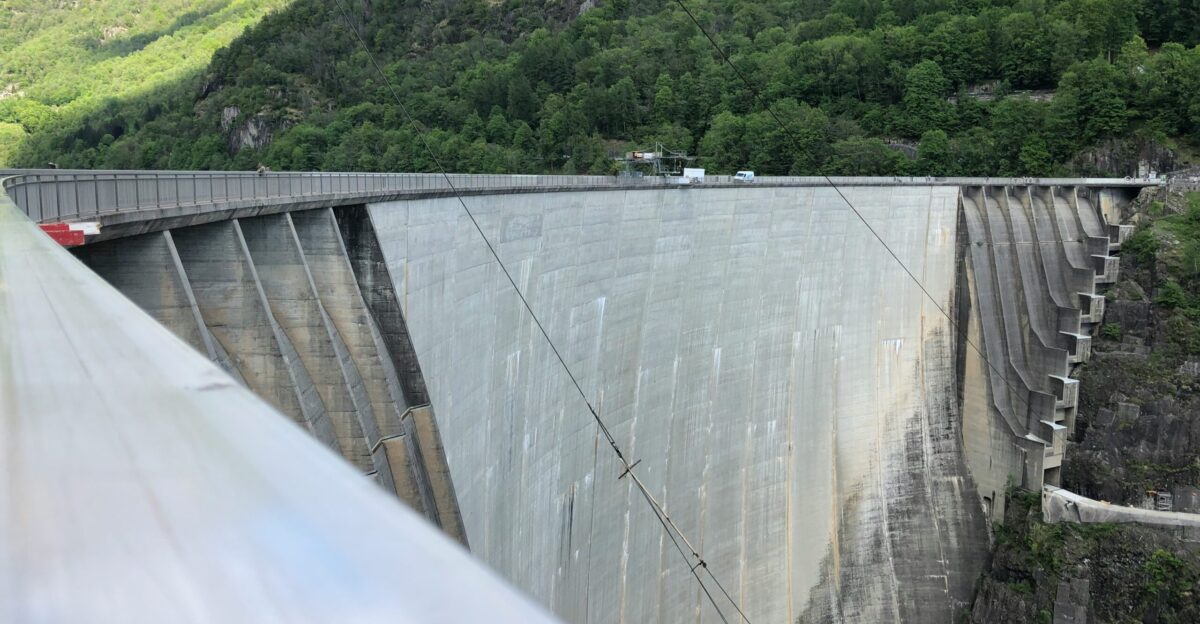 green grass field near gray concrete wall