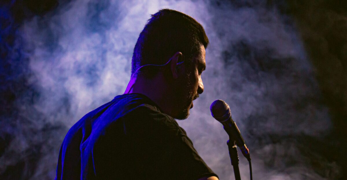 a man standing in front of a microphone