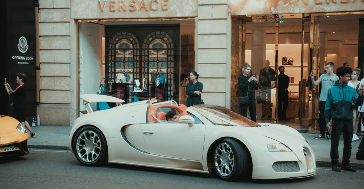white porsche 911 parked in front of building