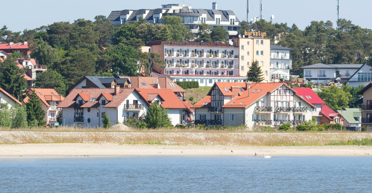 white and brown concrete building near body of water during daytime