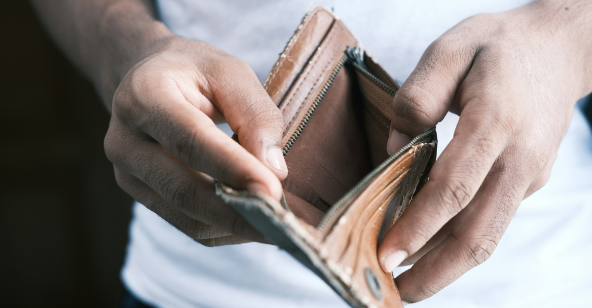 person holding brown leather bifold wallet