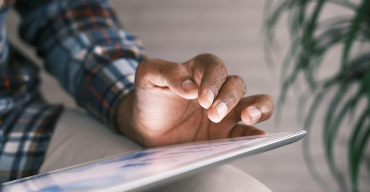 person in blue white and red plaid long sleeve shirt reading book