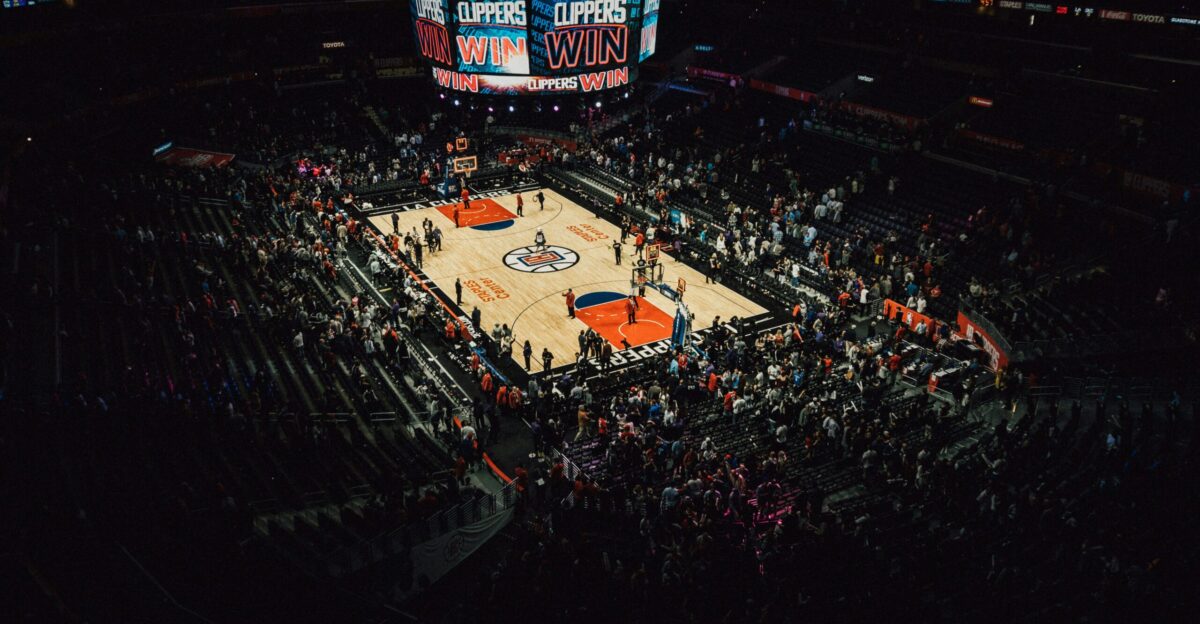 people watching football game during nighttime