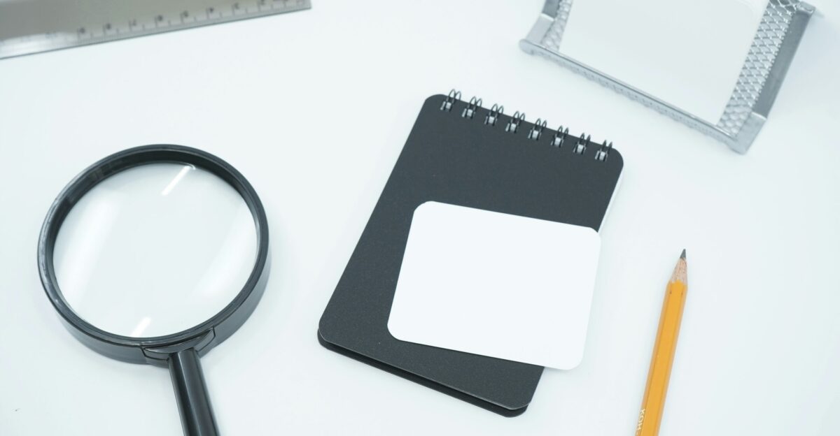 black magnifying glass on white paper