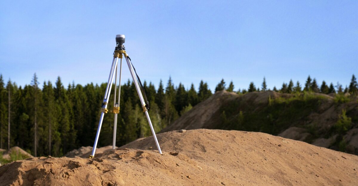 gray tripod on brown rock