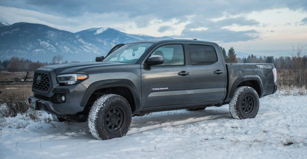 gray chevrolet crew cab pickup truck on snow covered ground during daytime