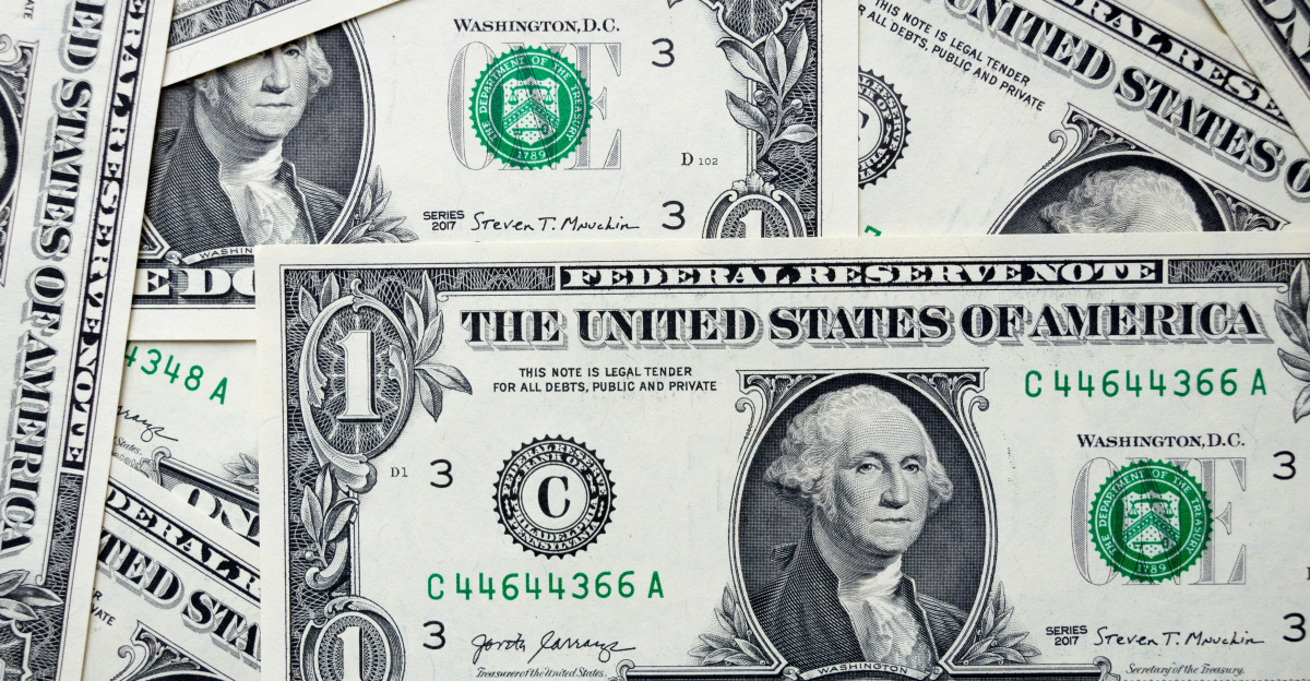 a pile of one dollar bills laying on top of each other