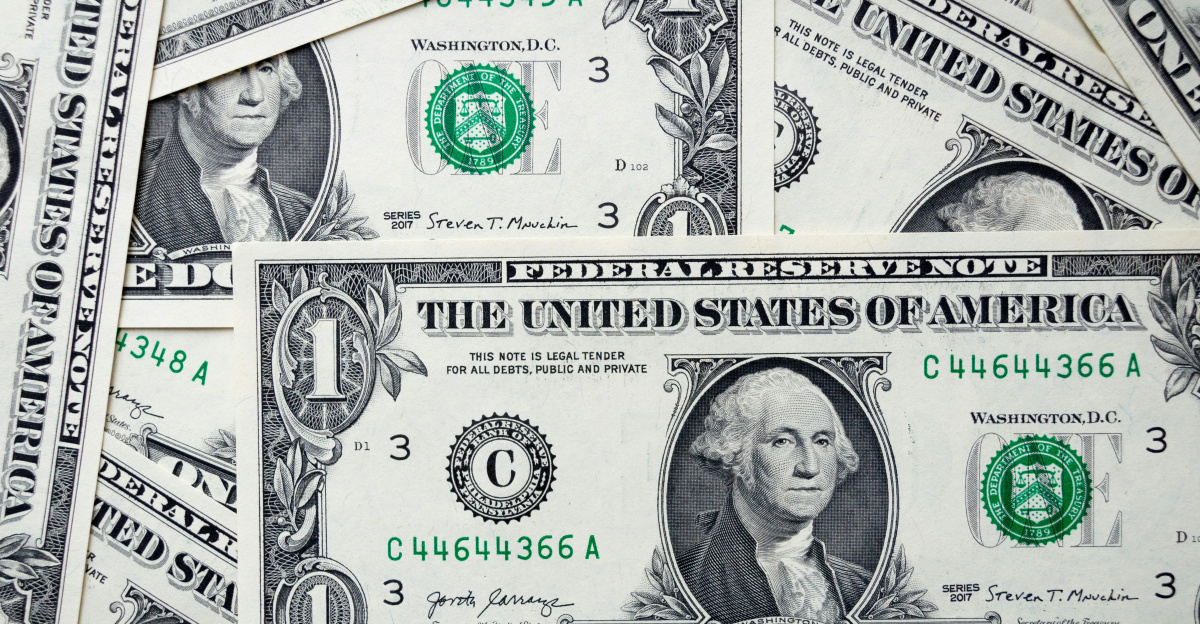 a pile of one dollar bills laying on top of each other