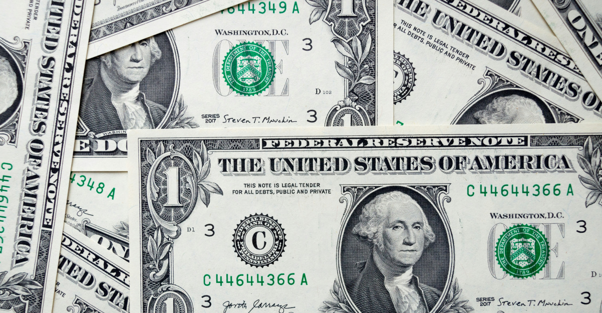 a pile of one dollar bills laying on top of each other