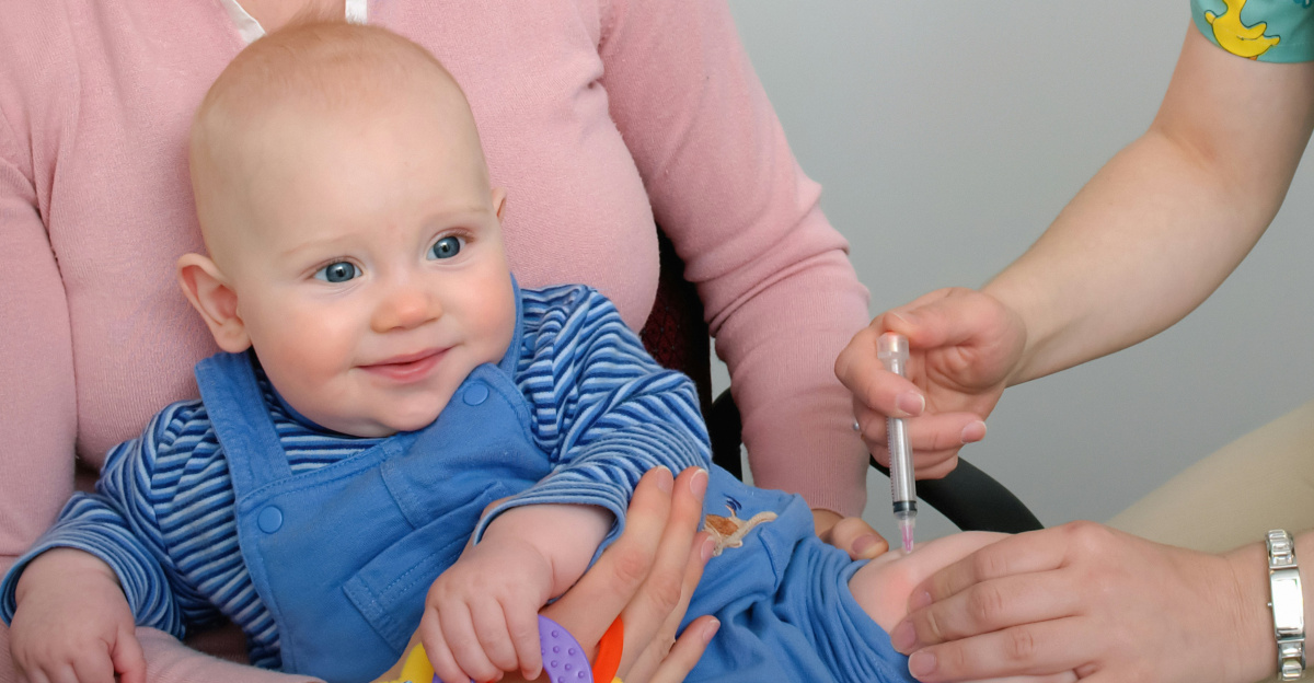 a woman in scrubs is holding a baby