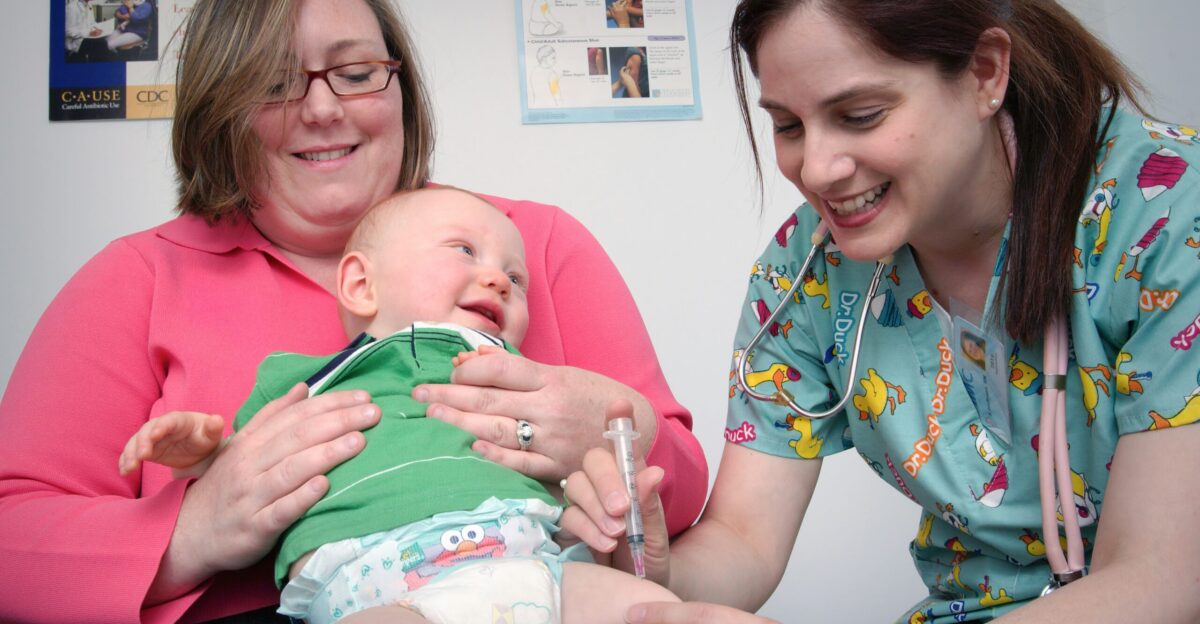 a woman holding a baby in a hospital room