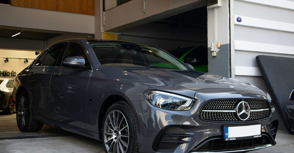 a car parked in a garage next to another car