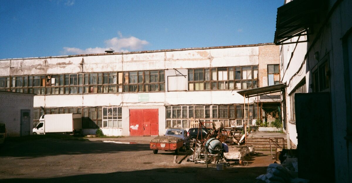 an old building with lots of windows and a red door