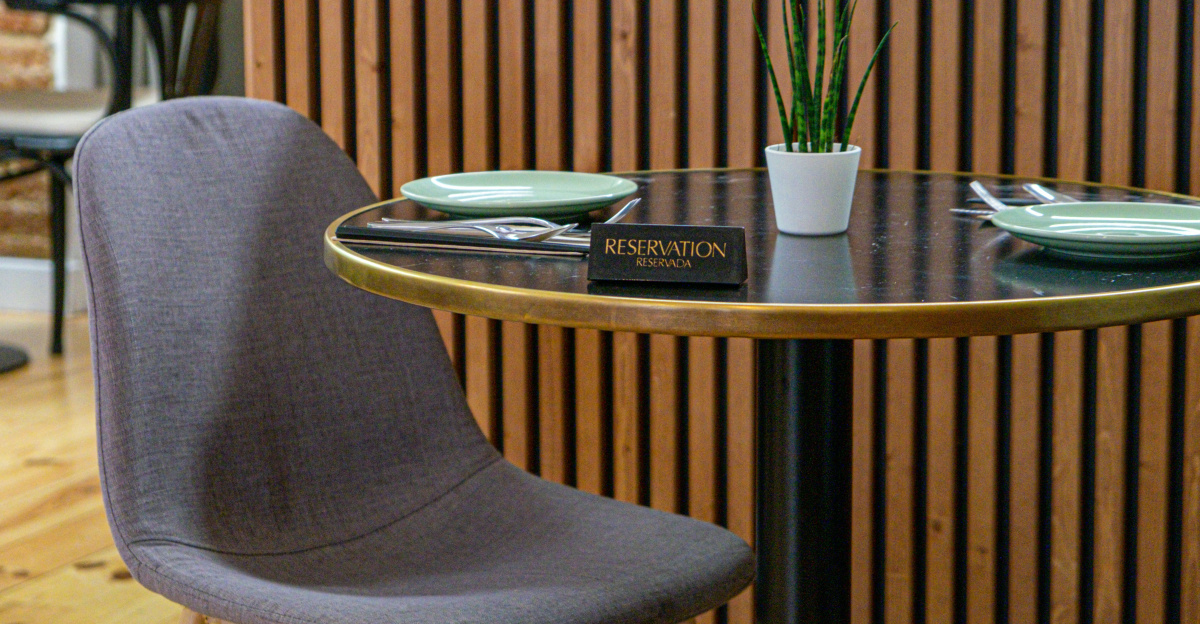 a table with two chairs and a potted plant