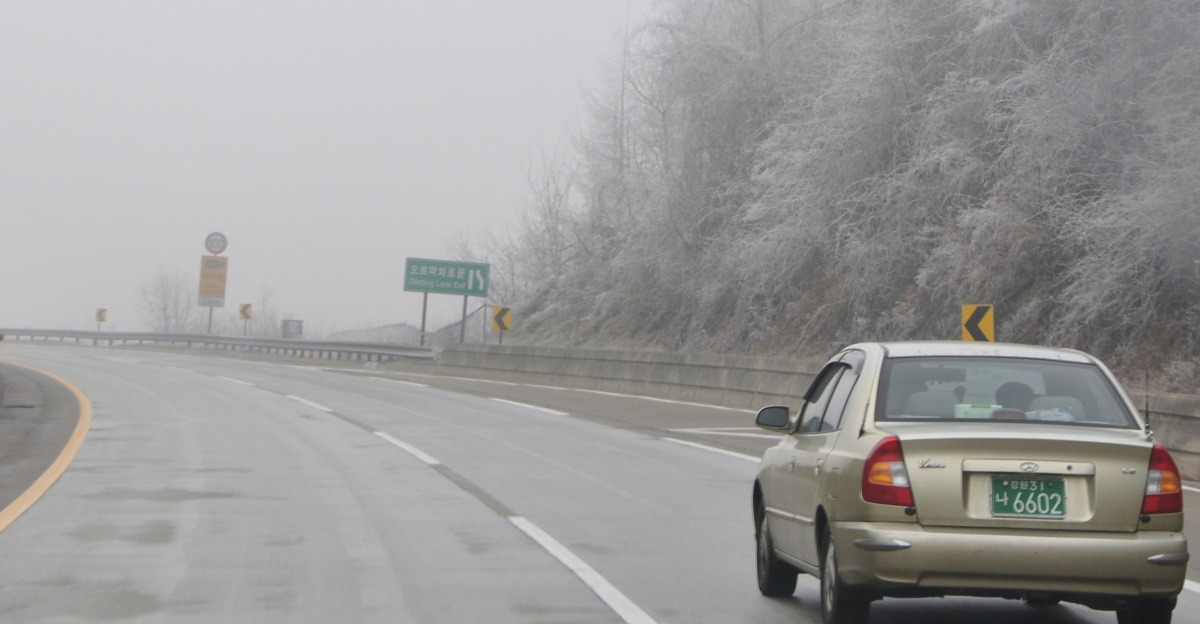 a car driving on a foggy highway
