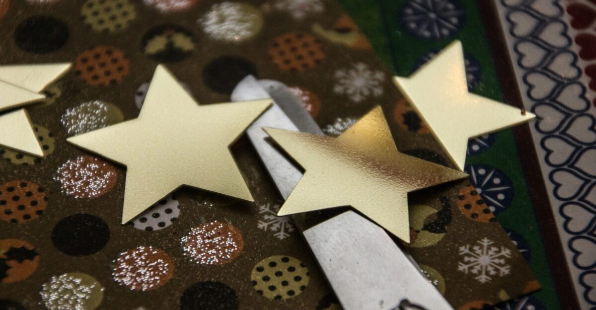 a pair of scissors sitting on top of a piece of paper