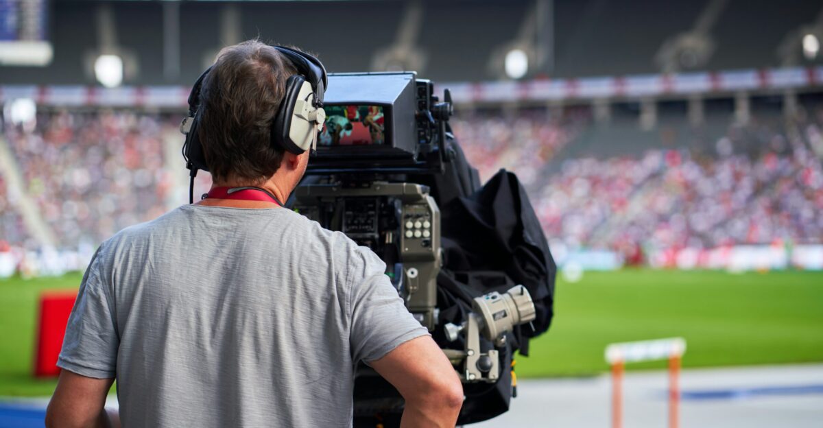 a man with headphones on sitting in front of a camera