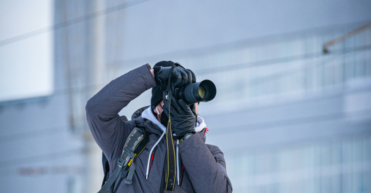 a man taking a picture of a building with a camera