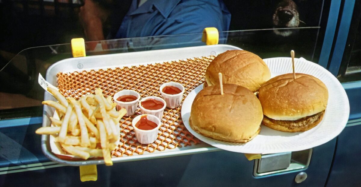 a tray with two hamburgers and french fries on it