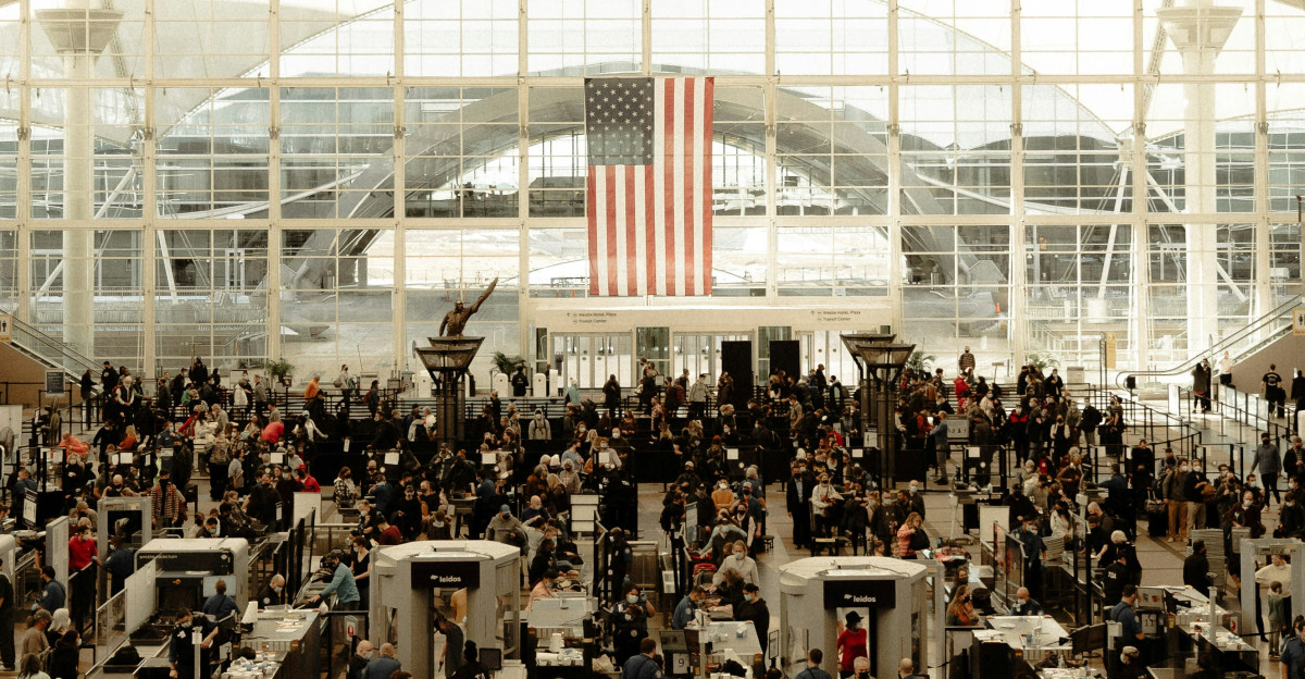 an airport filled with lots of people and luggage