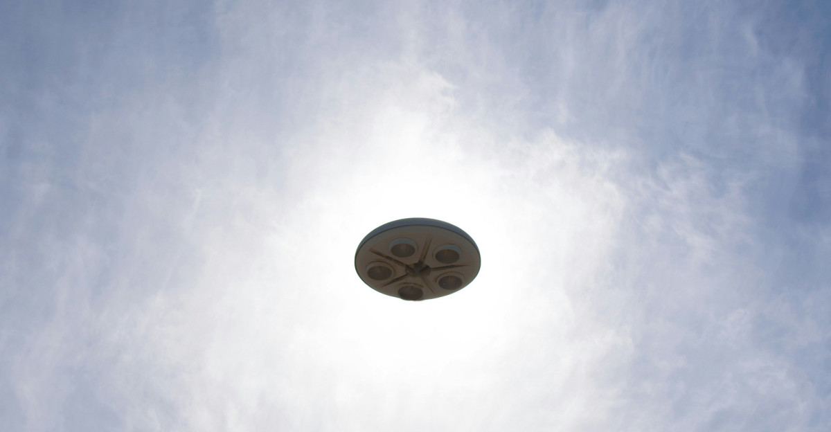 a frisbee flying through the air with a blue sky in the background