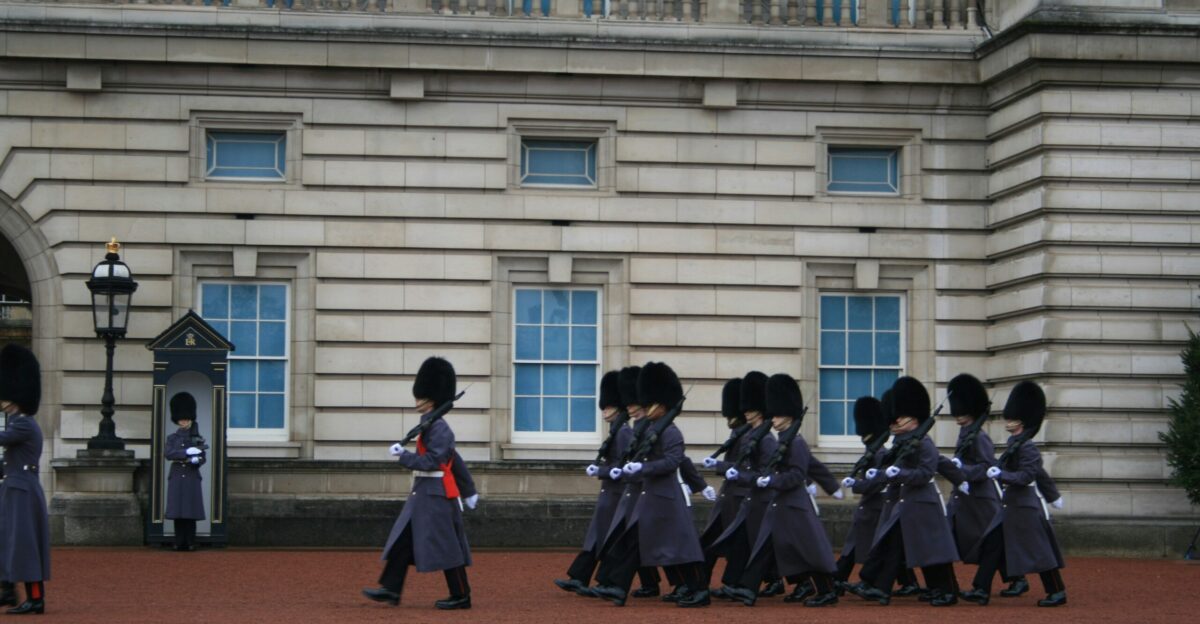 a group of men in uniform walking in front of a building