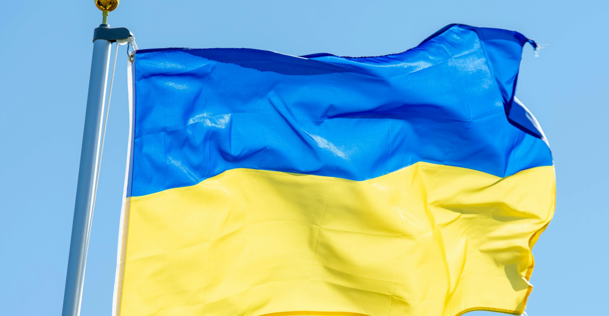 a blue and yellow flag flying in the wind