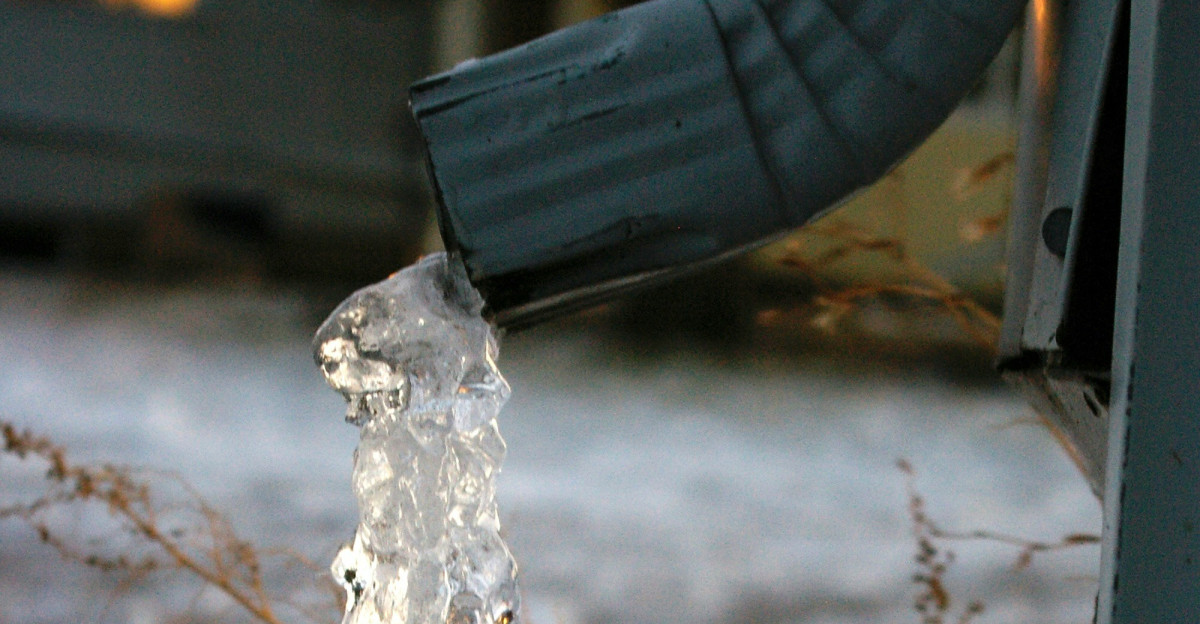 a person is pouring water from a faucet