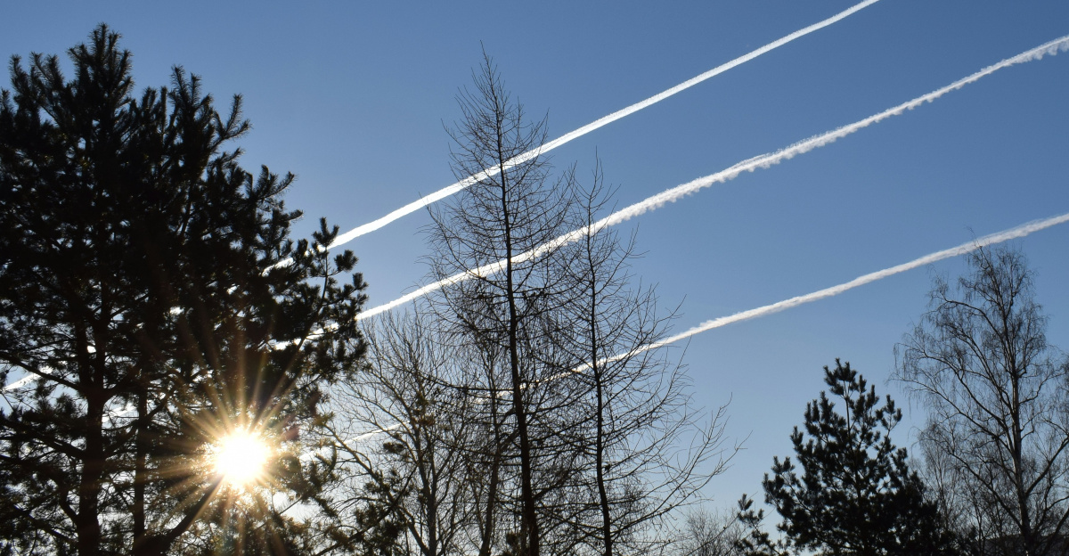a group of contrails flying through a blue sky
