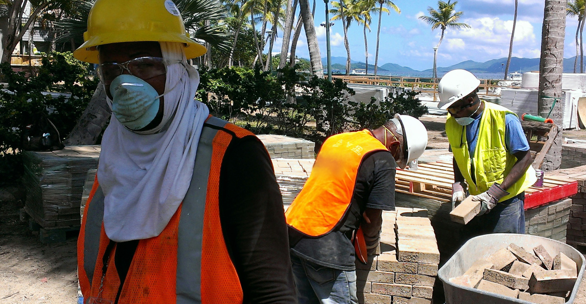 a group of people wearing safety vests and masks