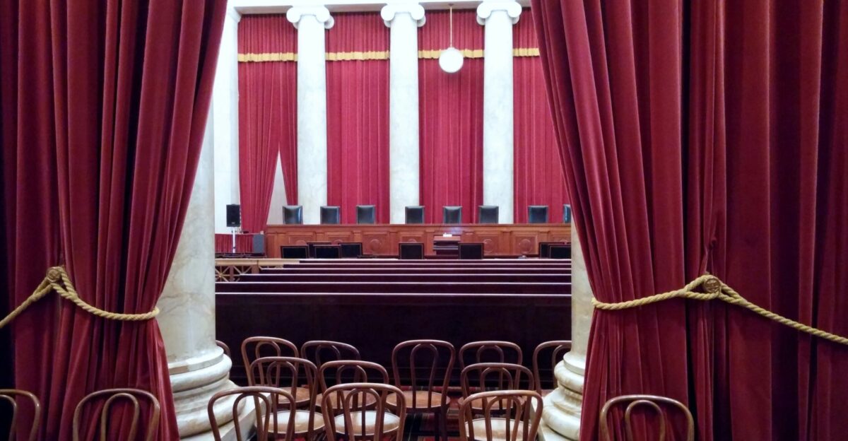 a room with red curtains and chairs in it