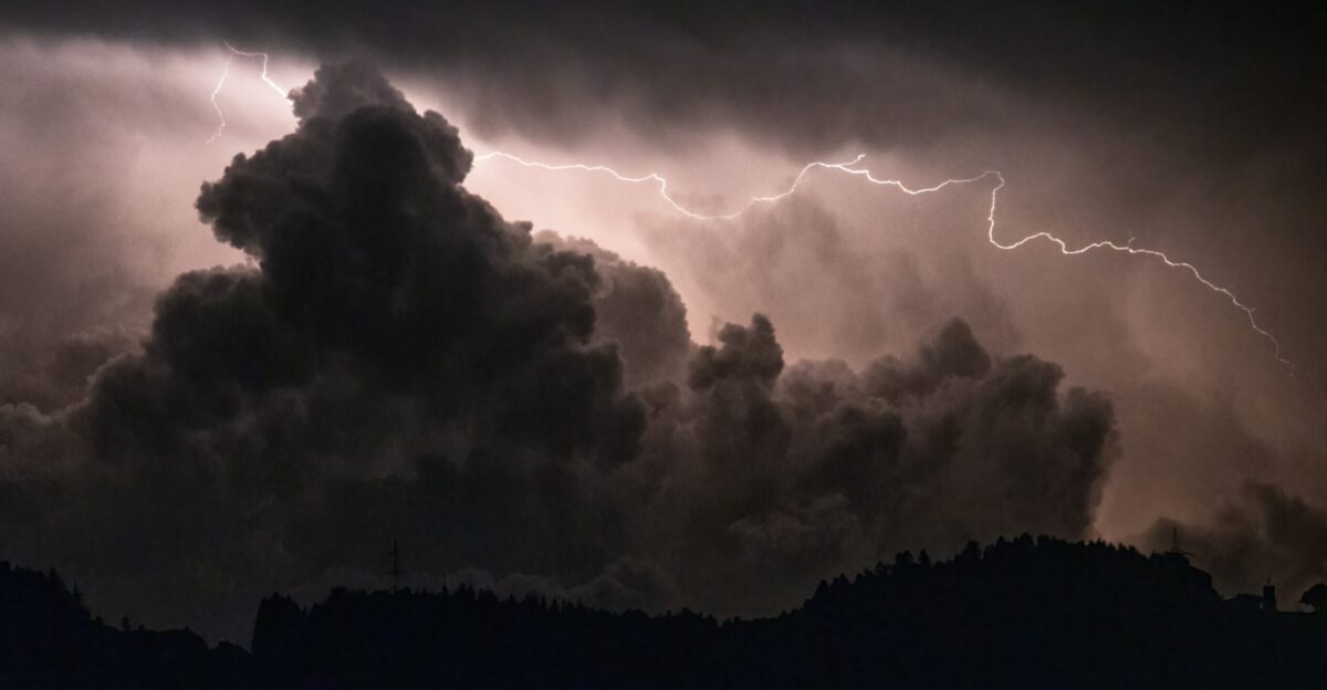 a large cloud with a lightning bolt in the sky