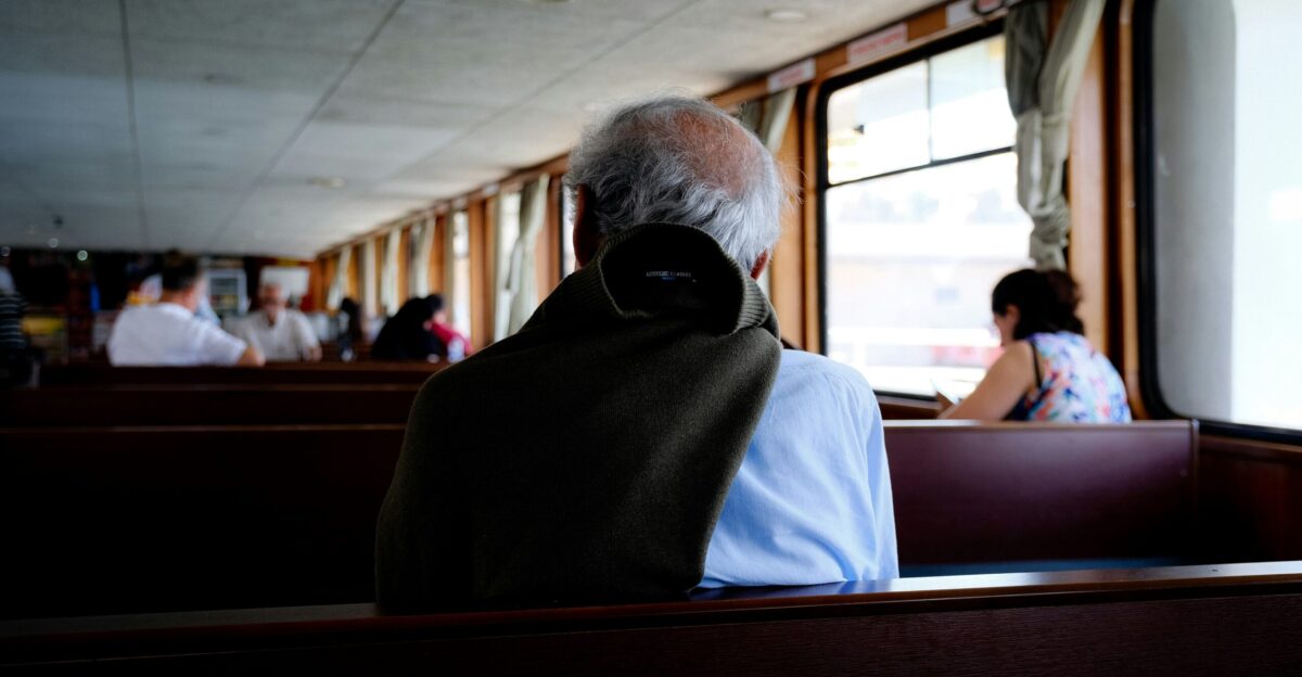 a person wearing a mask sitting on a bus