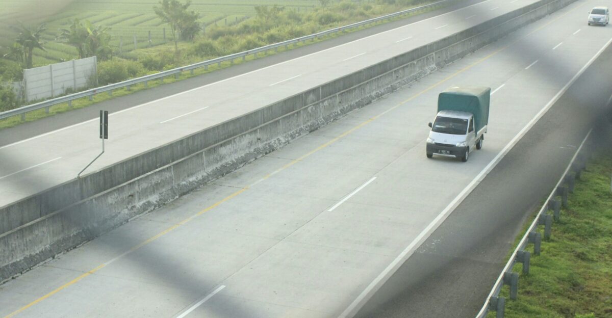a group of cars driving on a highway