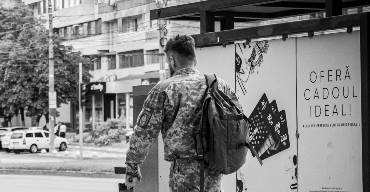 a person sitting on a bench next to a person sitting on a bench
