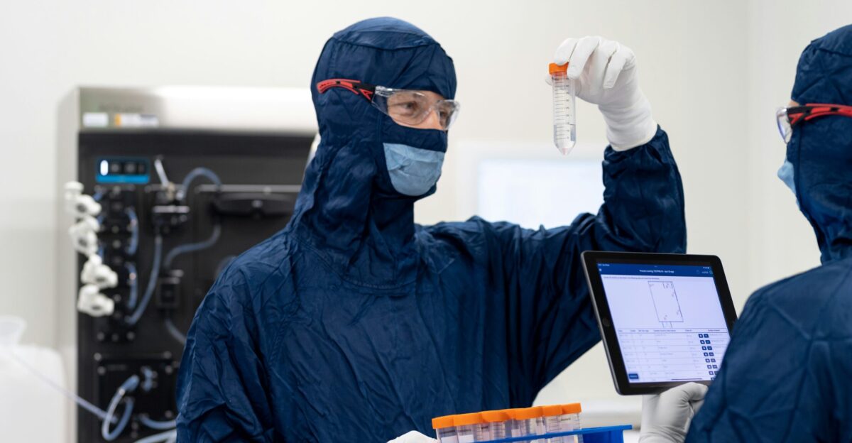 a group of people wearing protective gear and holding a tablet