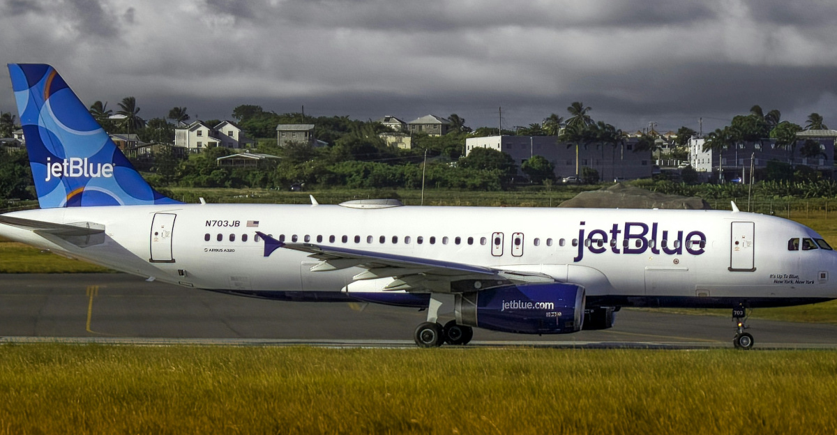 a jet blue airplane is on the runway