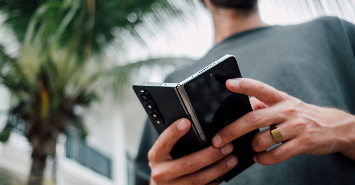 a man holding a smart phone in his hands