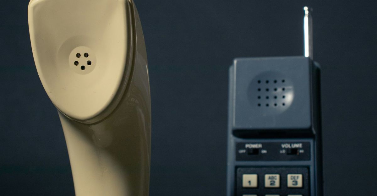 a telephone and a cell phone sitting next to each other