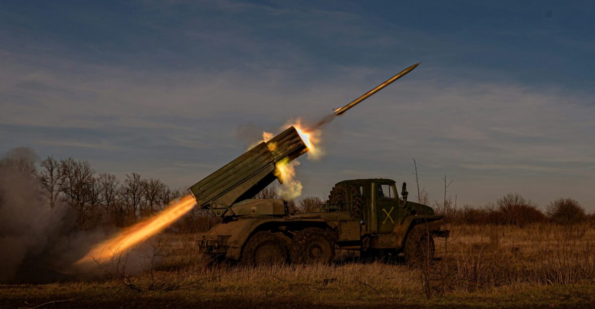 a military vehicle with a missile in the air