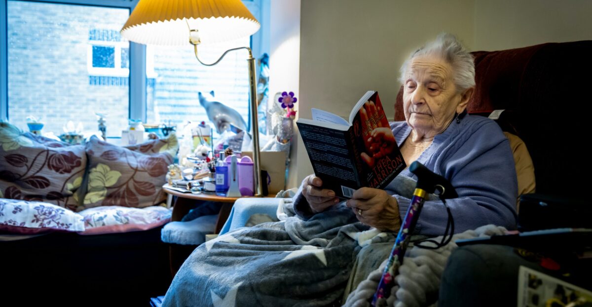 a woman sitting in a chair reading a book
