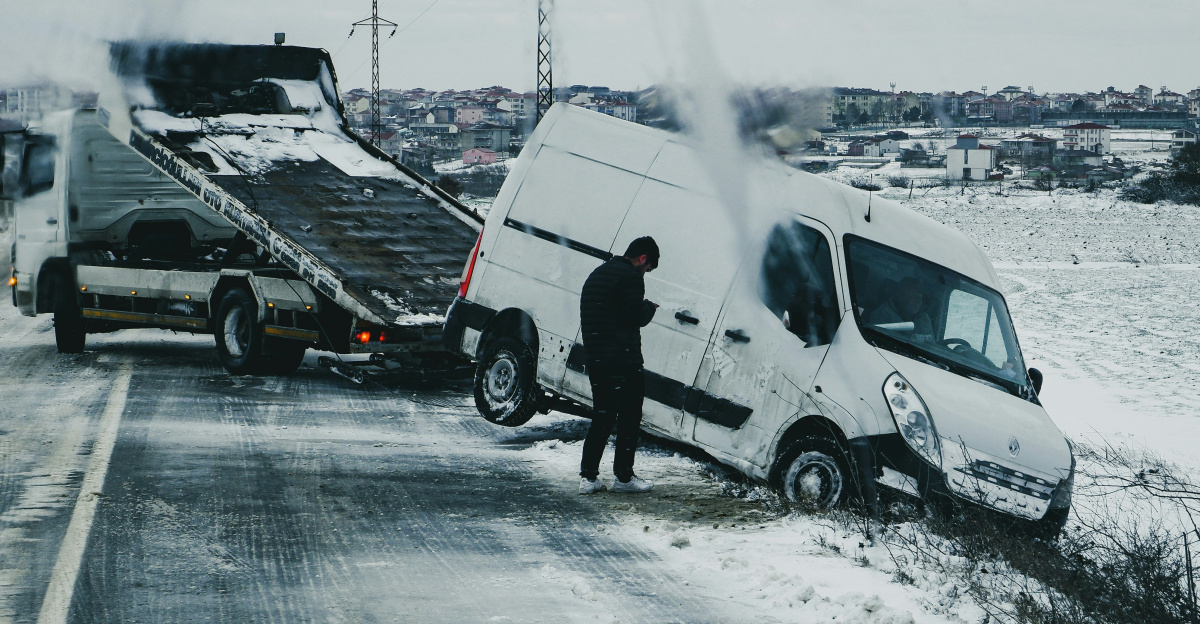 a man standing next to a white van on the side of a road