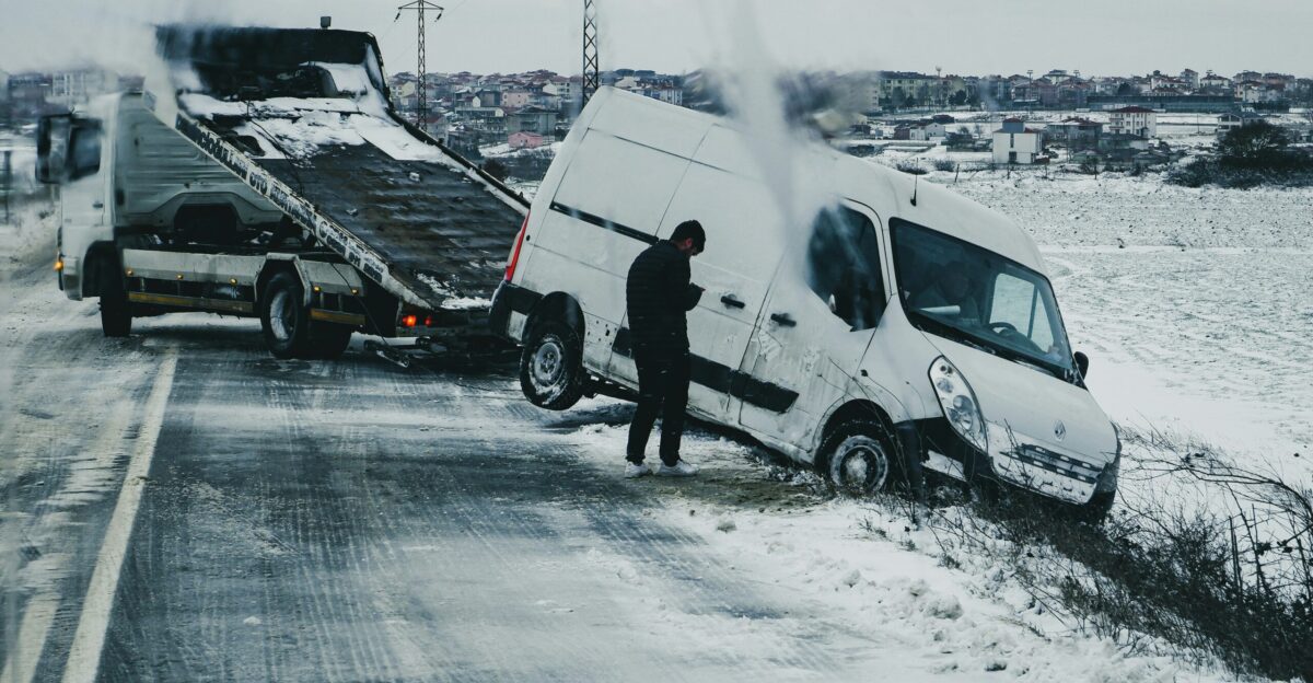 a man standing next to a white van on the side of a road