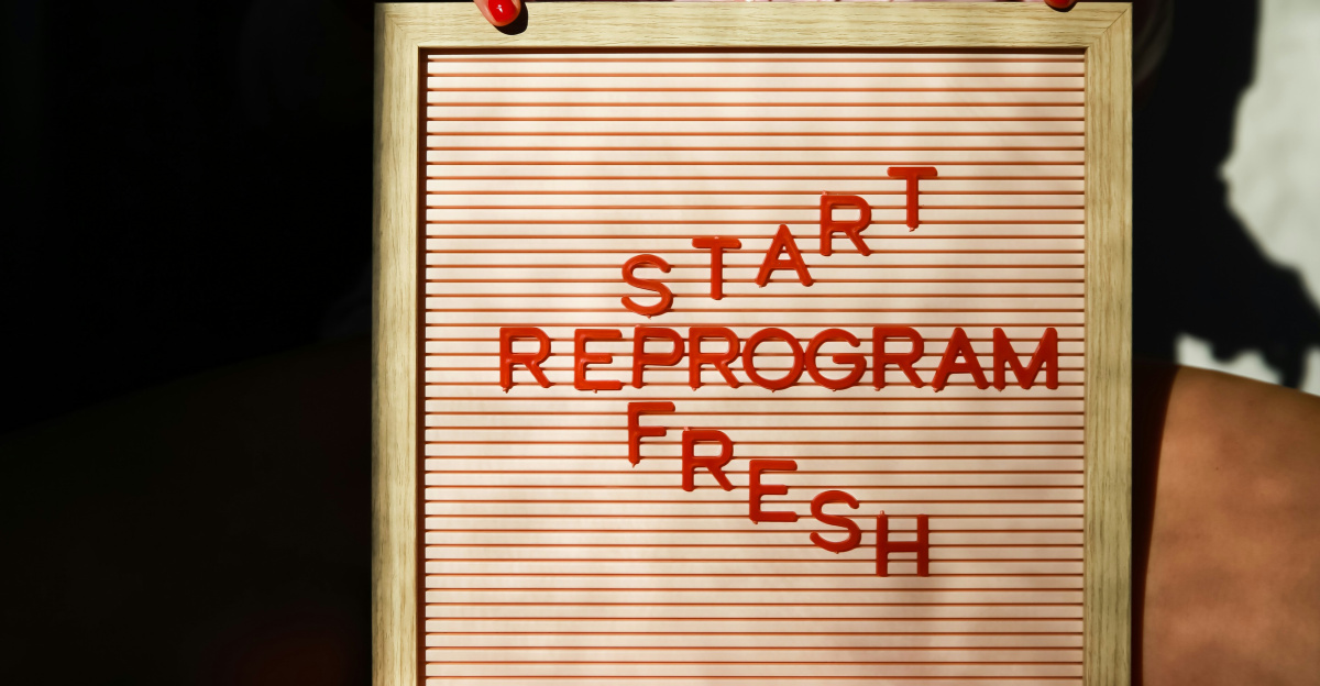 a person holding a sign that says start reprogram fresh
