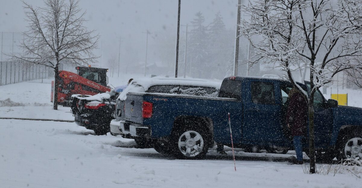 a couple of trucks are parked in the snow
