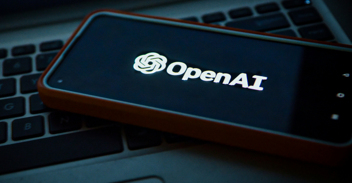 a cell phone sitting on top of a laptop computer