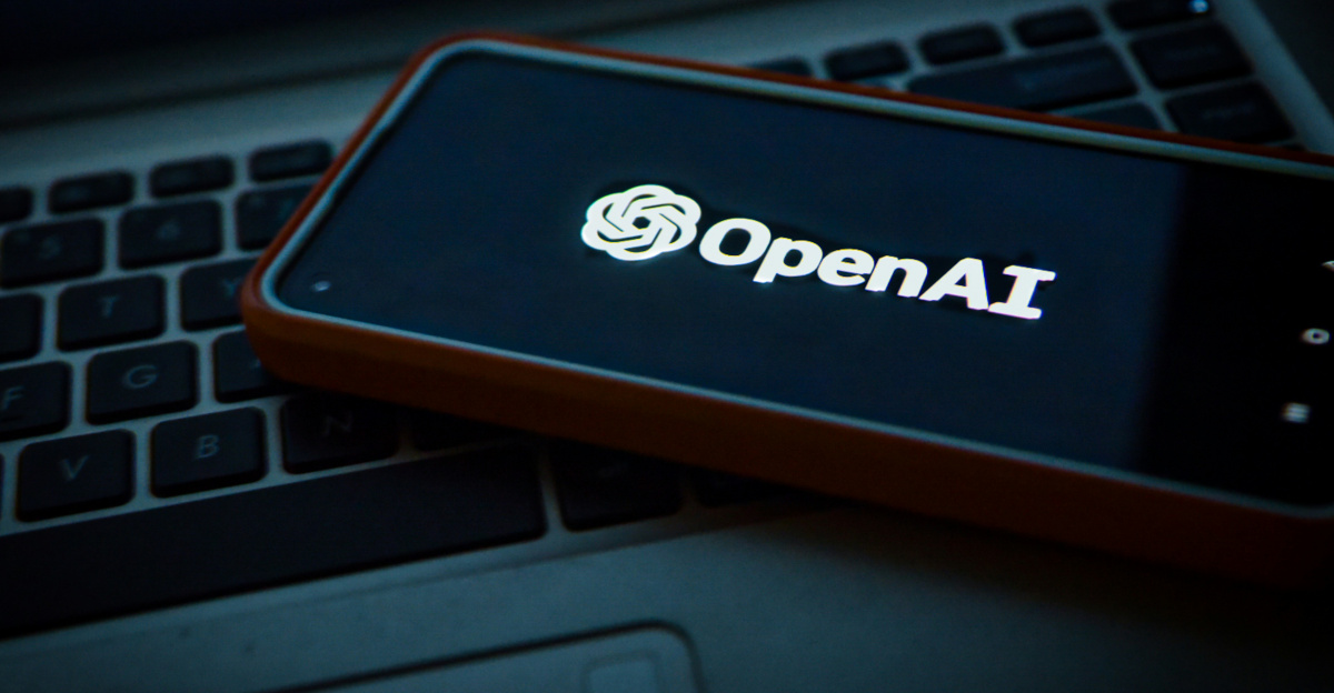 a cell phone sitting on top of a laptop computer